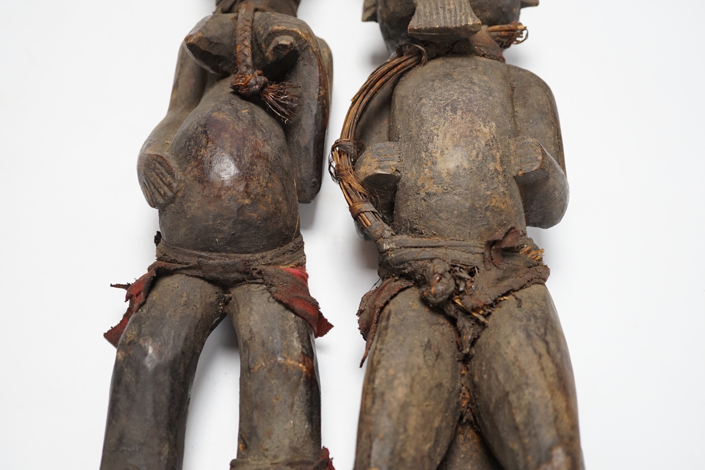 A pair of African tribal carved figures, tallest 53cm